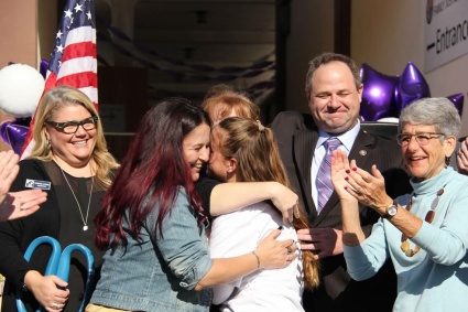 2 women embrace after cutting the ribbon at the Ventura County Family Justice Center Grand Opening